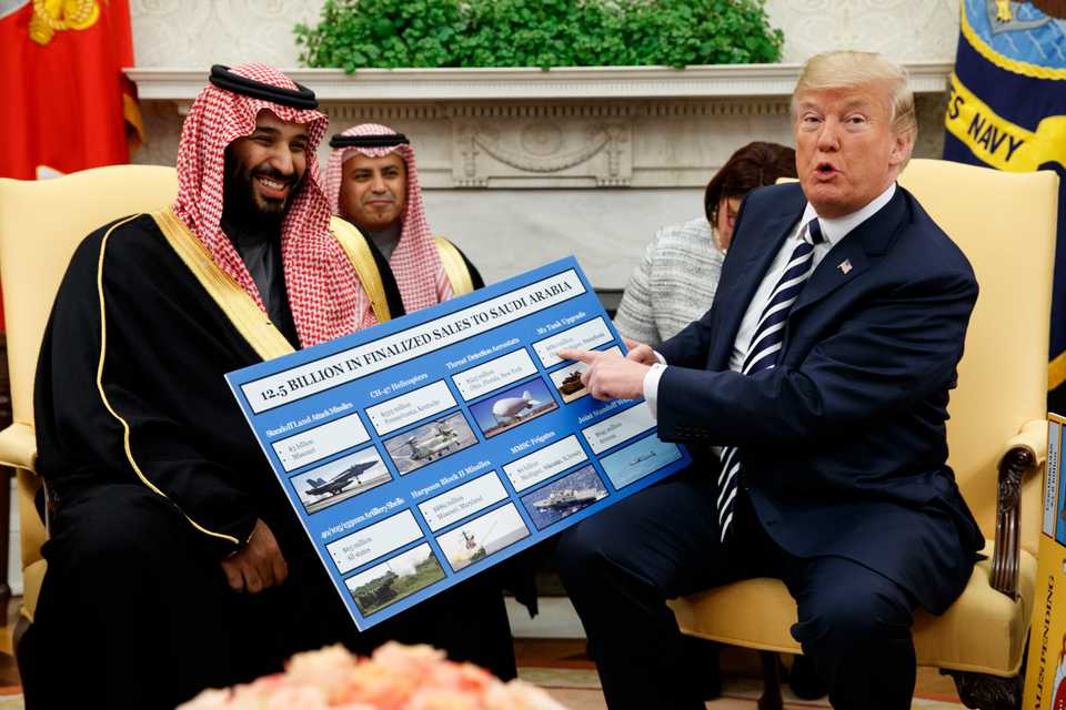 In this March 20, 2018 file photo, President Donald Trump shows a chart highlighting arms sales to Saudi Arabia during a meeting with Saudi Crown Prince Mohammed bin Salman in the Oval Office of the White House, in Washington.