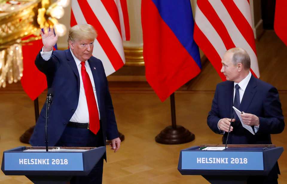 US President Donald Trump and Russian President Vladimir Putin react at the end of the joint news conference after their meeting in Helsinki, Finland, July 16, 2018.