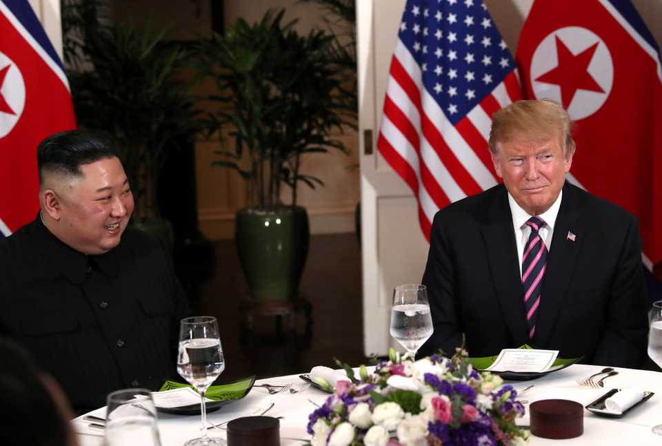 North Korean leader Kim Jong Un looks at US President Donald Trump as they sit down for dinner during the second US-North Korea summit at the Metropole Hotel in Hanoi, Vietnam February 27, 2019.