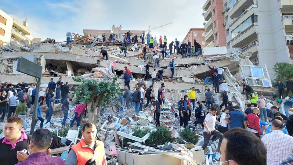 Locals and officials search for survivors at a collapsed building in the coastal province of Izmir, Turkey, October 30, 2020.
