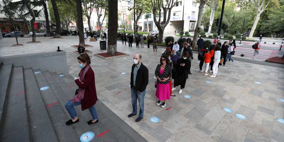People line up outside a polling station during a parliamentary election in Tbilisi, Georgia October 31, 2020.