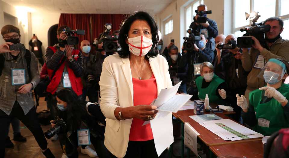 Georgia's President Salome Zurabishvili holds a ballot before casting her vote at a polling station during a parliamentary election in Tbilisi, Georgia October 31, 2020.