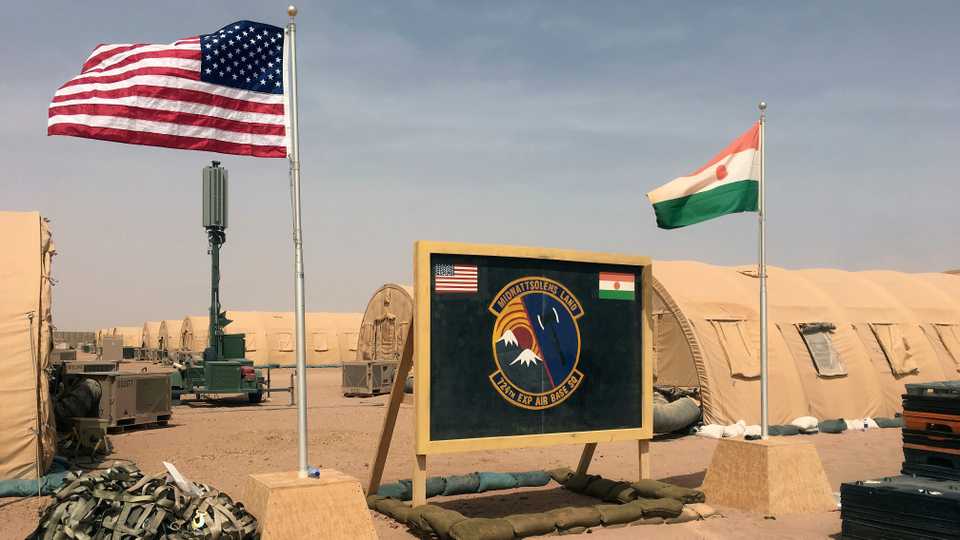 A US and Niger flag are raised side by side at the base camp for air forces and other personnel supporting the construction of Niger Air Base 201 in Agadez, Niger, April 16, 2018.