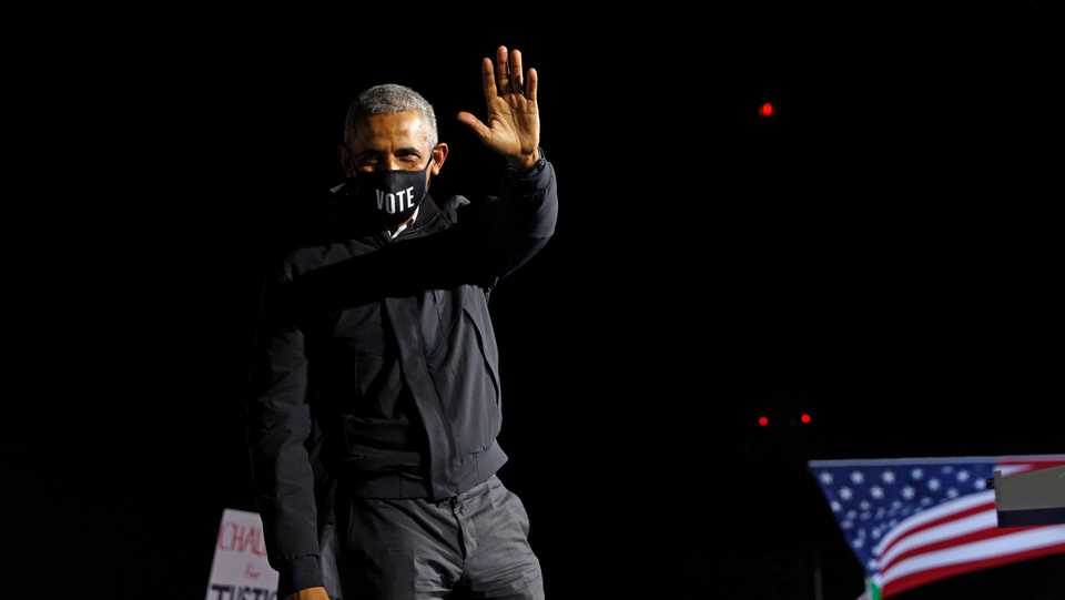 Former US President Barack Obama waves on stage in Detroit, Michigan, US, October 31, 2020.
