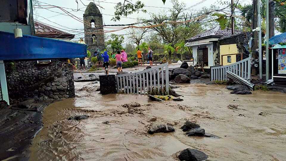 Floodwaters pass by Cagsawa ruins, a famous tourist spot in Daraga, Albay province, central Philippines. November 1, 2020.