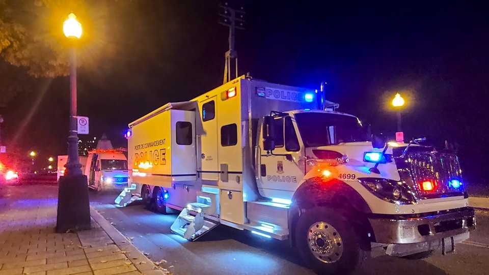 A police truck is parked near the National Assembly of Quebec, in Quebec City, early on November 1, 2020, after two people were killed and five wounded by a sword-wielding suspect dressed in medieval clothing.