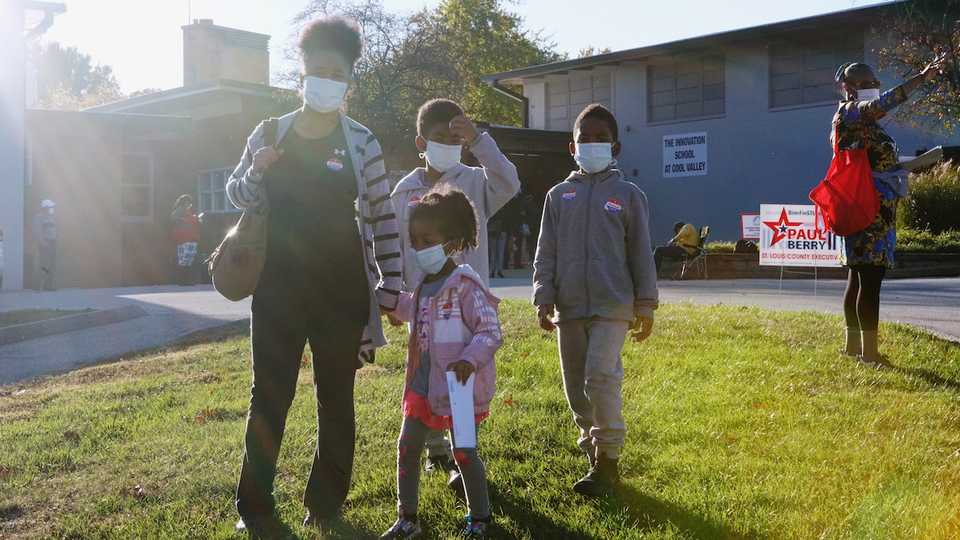 Voters wearing face masks due to the ongoing coronavirus outbreak are seen at a Ferguson polling station during Election Day in Missouri, US, on November 3, 2020.