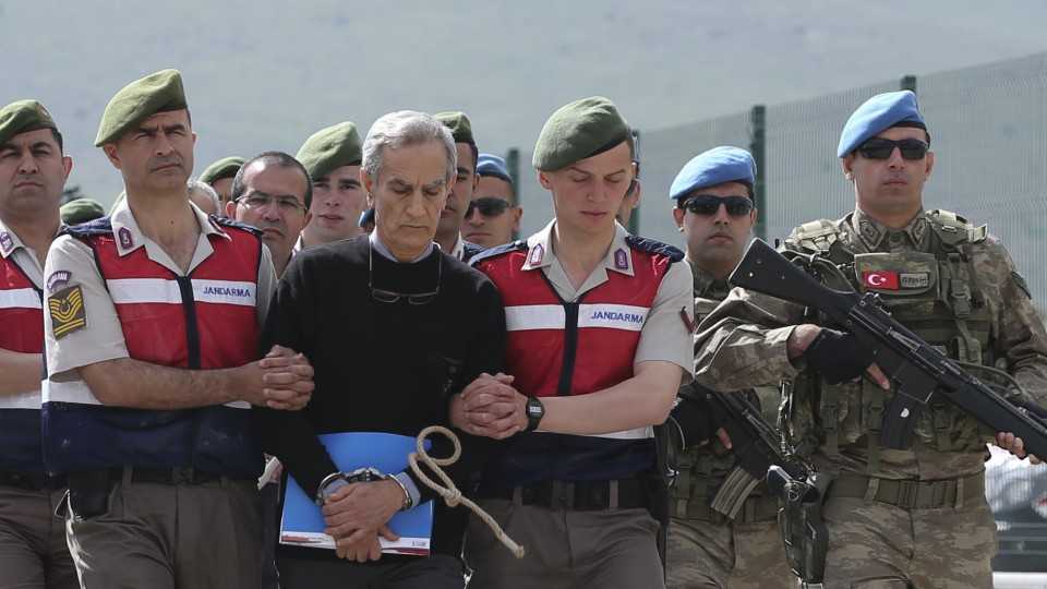 Turkish Gendarmerie escort defendants Akin Ozturk (C) and others accused of taking part in the July 15, 2016 attempted coup in Turkey, ahead of the start of their trial in Ankara on May 22, 2017.