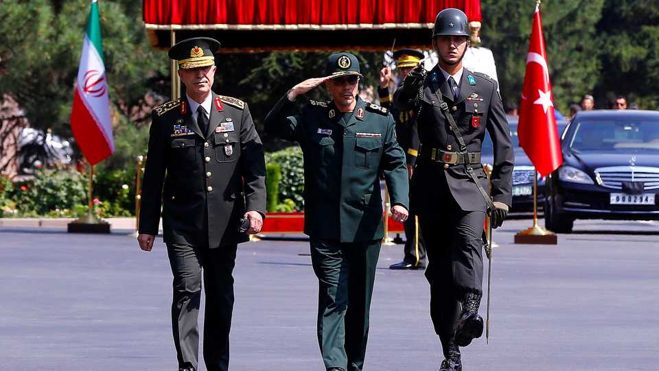 Turkish Chief of Staff General Hulusi Akar and his Iranian counterpart Major General Mohammad Baqeri review the guards of honour during a welcoming ceremony in Ankara, Turkey, on August 15, 2017.