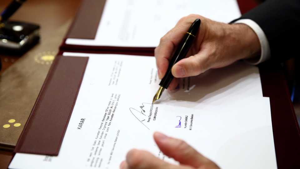 Turkeys President Recep Tayyip Erdogan signs a document at the Presidential Palace in Ankara, Turkey, August 2, 2017. 