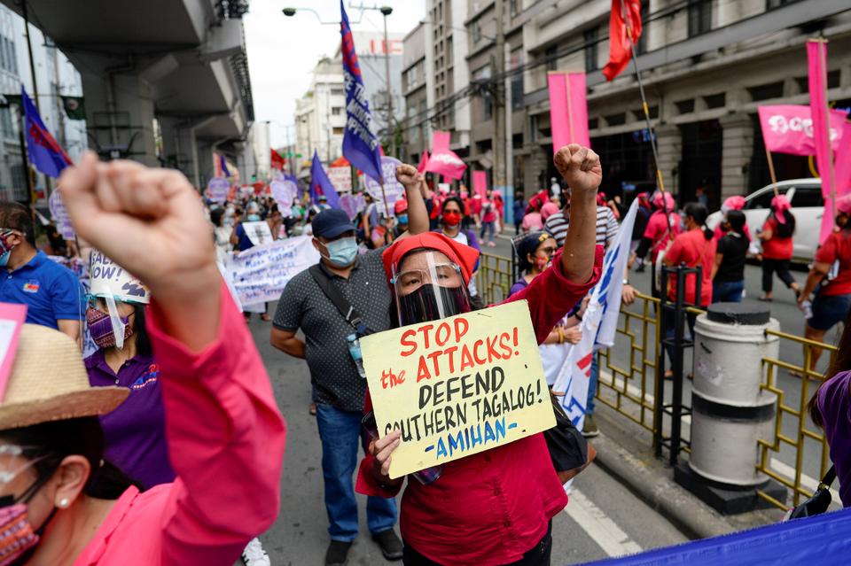 Filipino demonstrators gesture while holding placards and banners as they attend a protest during the International Women's Day, in Manila, Philippines, on March 8, 2021.