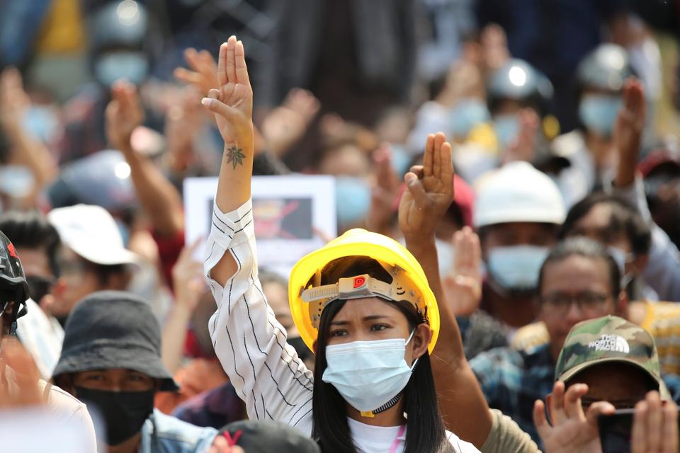 A woman shows a three-finger salute during a protest against the military coup in Naypyitaw, Myanmar, March 8, 2021.