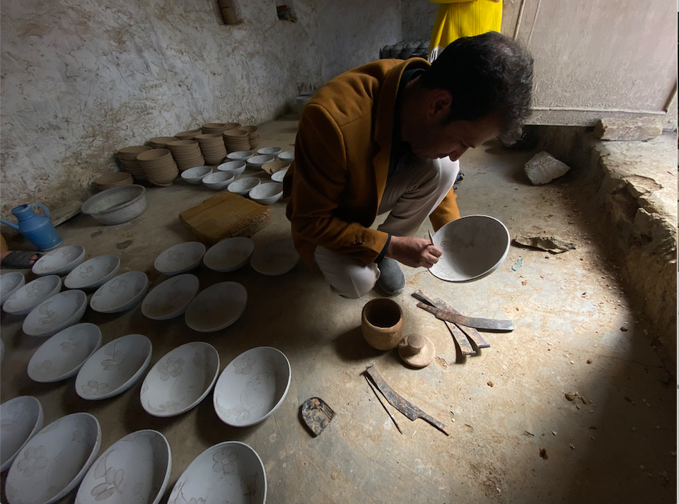 An Afghan potter working on a piece of ceramic bowl in Istalif