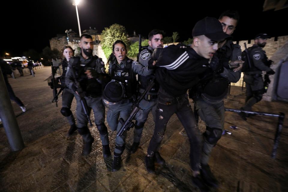 Israeli border police detain a Palestinian youth during clashes near Damascus Gate just outside Jerusalem's Old City, on the Muslim holy fasting month of Ramadan April 21, 2021