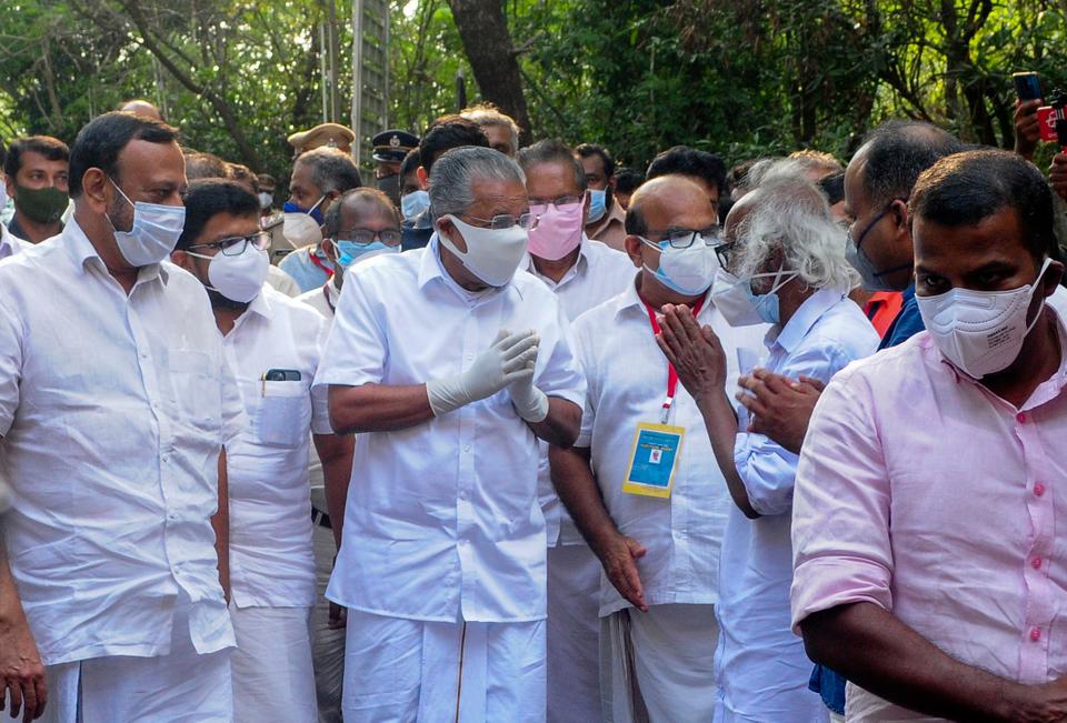 Kerala Chief Minister Pinarayi Vijayan, center, greets other leaders and supporters as he arrives at a vote counting center following the left democratic front's victory in the state legislature elections in Kannur, Kerala, Sunday, May 2, 2021.