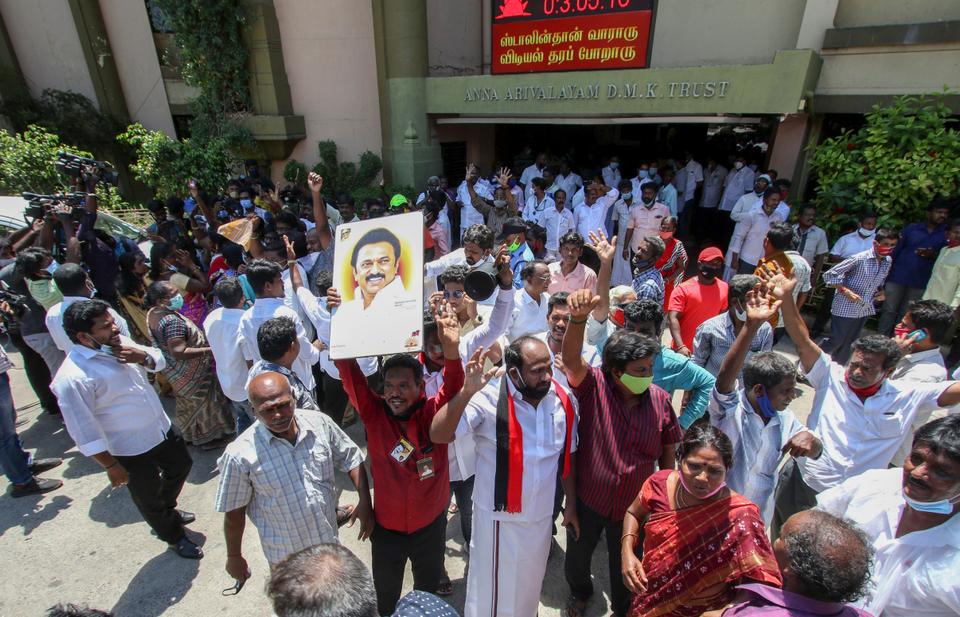 Dravida Munnetra Kazhagam (DMK) party cadres display a photograph of their leader M.K. Stalin as they celebrate early leads for the party in the Tamil Nadu state assembly elections in Chennai, India, Sunday May 2, 2021.