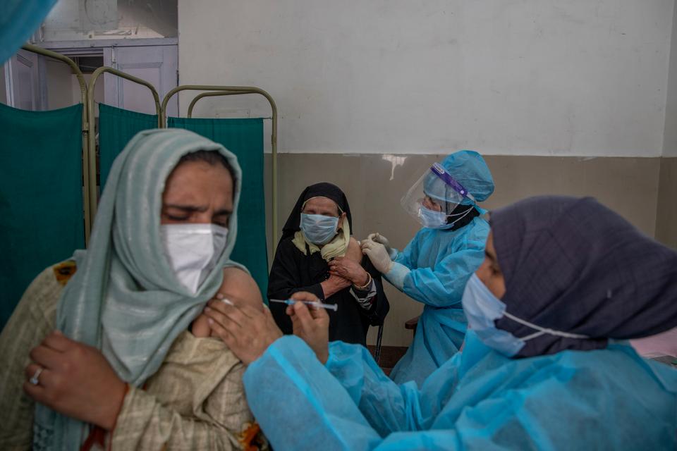 Kashmiri women receive COVISHIELD vaccine for Covid-19 at a primary health center in Srinagar, Indian-administered Kashmir, Wednesday, April 28, 2021.