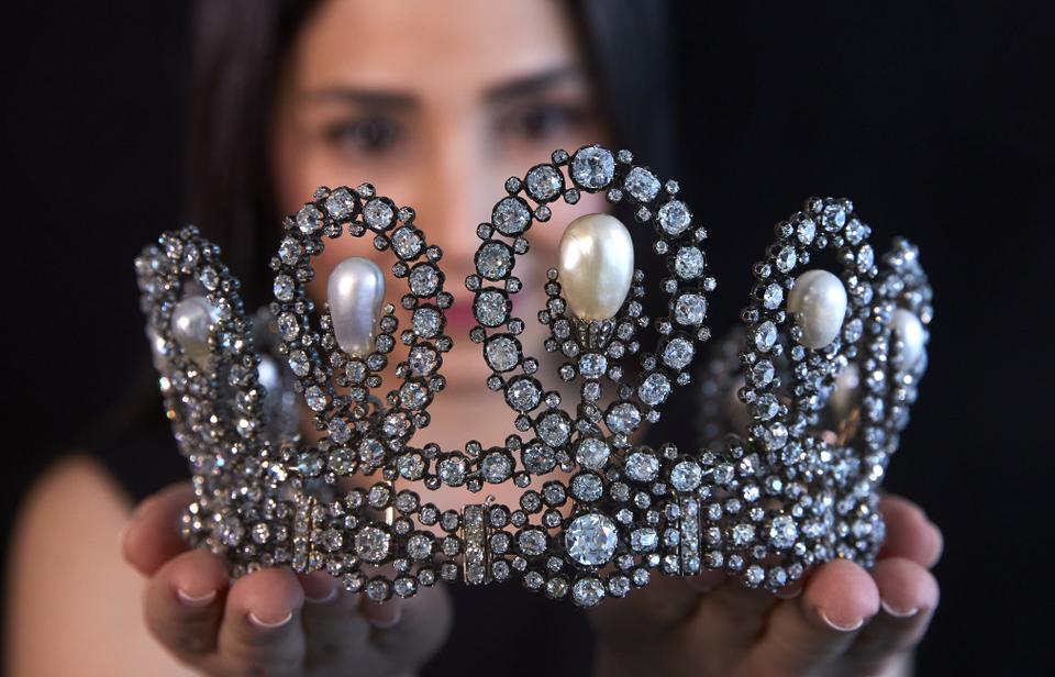 A staff holds a diamond and pearl tiara passed down through generations of the Italian royal family during a preview at Sotheby's before their auction in Geneva, Switzerland, on May 6, 2021.