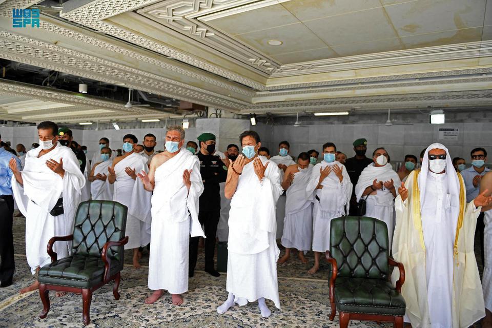 A handout picture provided by the Saudi Press Agency (SPA) on May 9, 2021 shows Pakistan's Prime Minister Imran Khan (C) performing the Umrah pilgrimage in the holy city of Mecca.