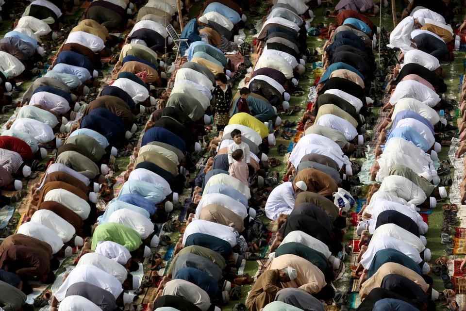 Muslims perform an Eid al Fitr prayer in an outdoor open area with no social distancing in Karachi, Pakistan.