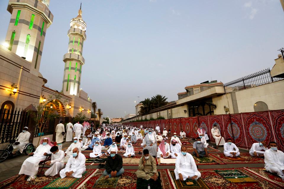 Muslims wearing masks and keeping social distancing to curb the spread of coronavirus outbreak, perform an Eid al-Fitr prayer marking the end of the holy fasting month of Ramadan at al-Mirabi Mosque in Jiddah, Saudi Arabia.