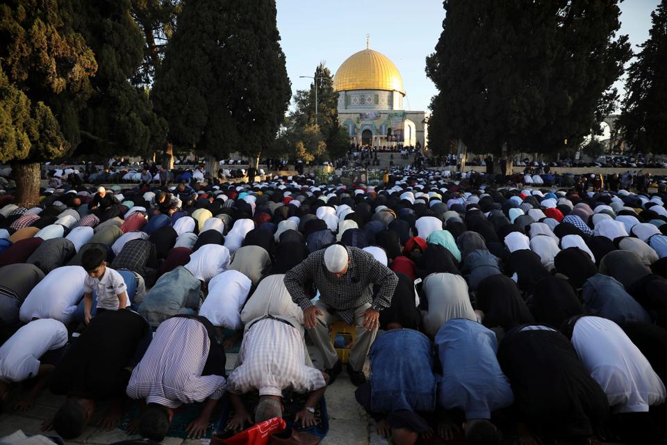 Muslims take part in Eid al-Fitr prayers at the Dome of the Rock Mosque in the Al-Aqsa Mosque compound in the Old City of Jerusalem, May 13, 2021.