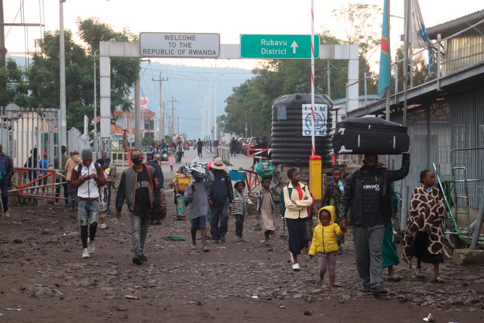 People who fled to Rwanda during the overnight eruption of Mount Nyiragongo return to Goma, Democratic Republic of Congo on May 23, 2021.