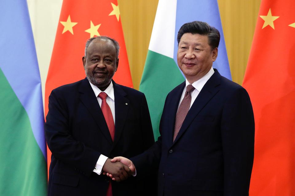 Djibouti's President Ismail Omar Guelleh, left, poses with Chinese President Xi Jinping in Beijing in 2018. While Djibouti remains financially indebted to China, it has received several benefits culturally, such as a new lavish national theater, training for radio staff in analog technology, and other guarantees of cultural infrastructure in the pipeline.