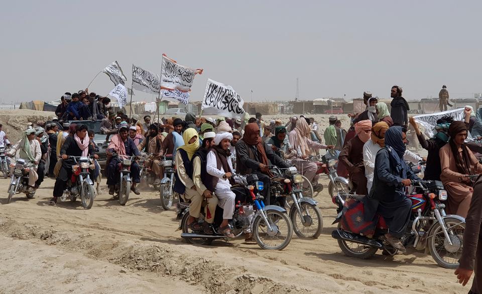 Supporters of the Taliban carry the Taliban's signature white flags in the Afghan-Pakistan border town of Chaman. Pakistan is concerned about the changing security scenario along its Afghan border.