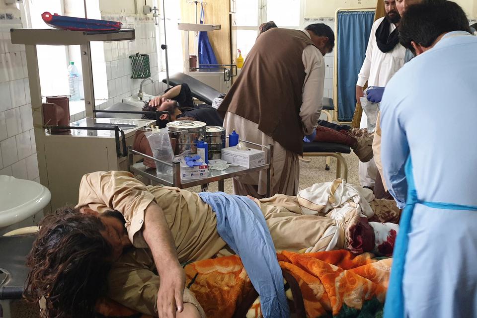 Pakistani paramedics treat men, who were injured in a fighting between Afghan security forces and Taliban in SpinBoldak border area, at a hospital in Chaman, Pakistan, Friday, July 16, 2021.