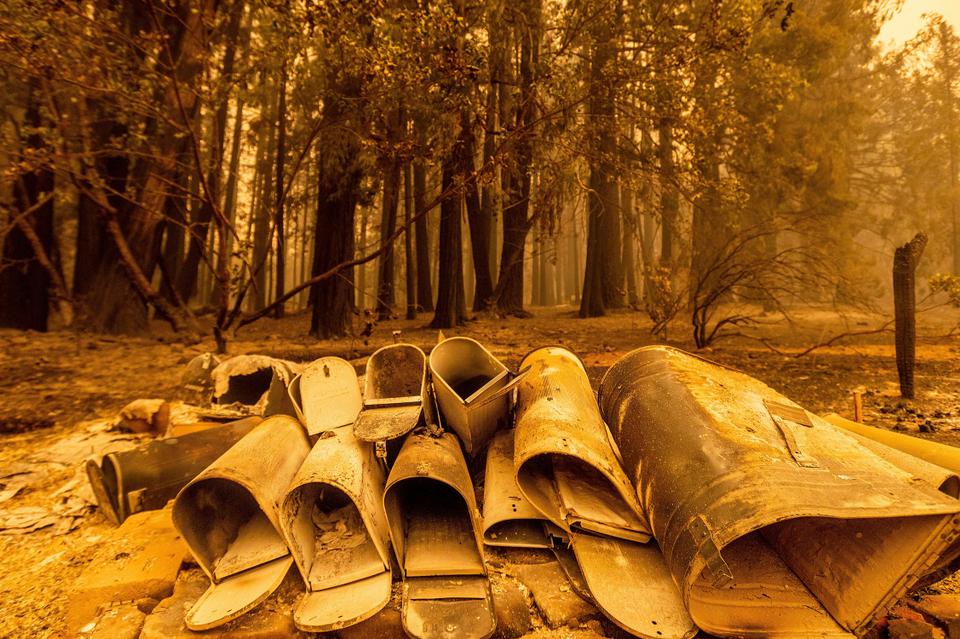 Scorched mailboxes lie on the ground after the Dixie Fire passed through the Indian Falls community of Plumas County, California, Sunday, July 25, 2021.