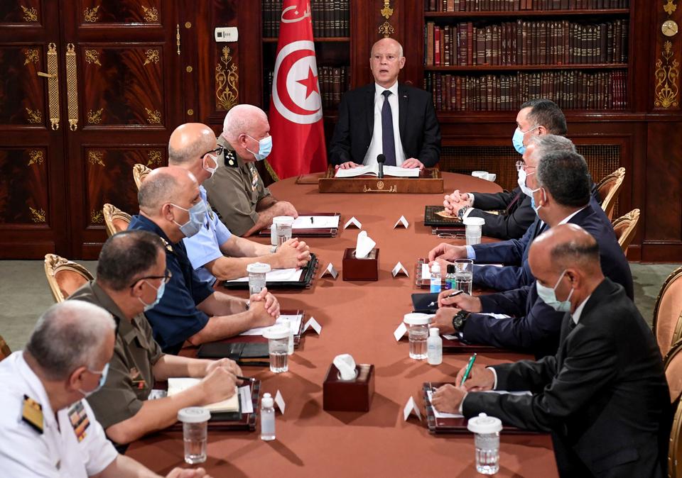 Tunisia's President Kais Saied, center, leads a security meeting with members of the army and police forces in Tunis, July 25, 2021. The president suspended the legislature and fired the prime minister on Monday following nationwide protests over the country's economic troubles and the government's handling of the Covid-19 crisis.