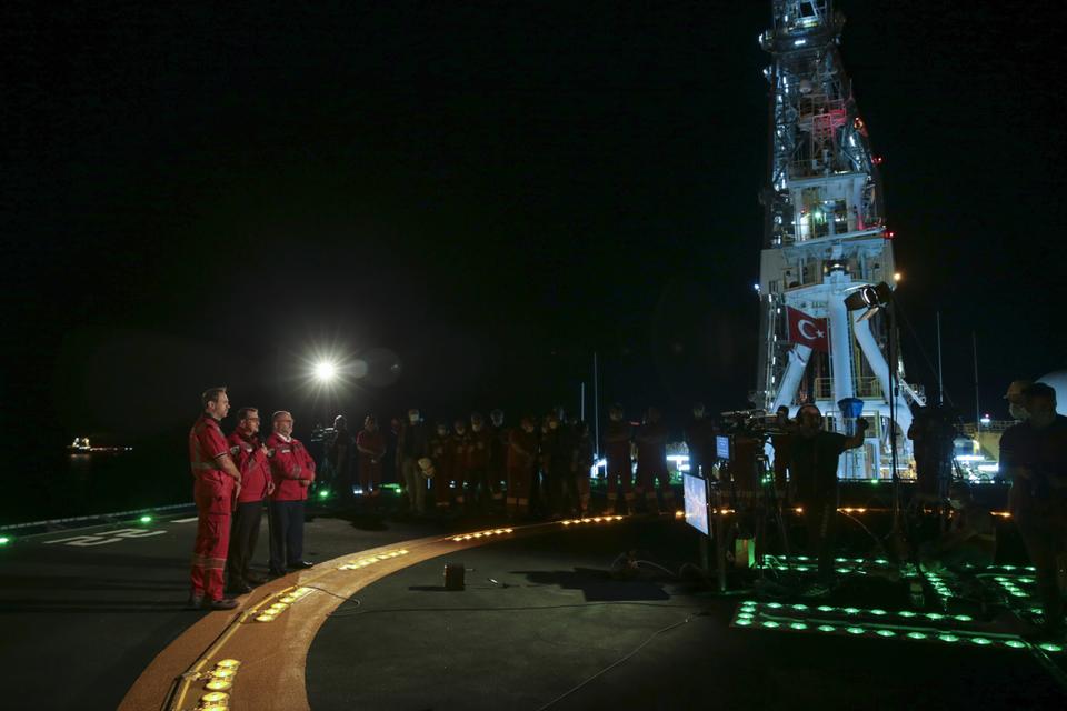 Minister of Energy and Natural Resources, Fatih Donmez (2nd L) stands on the deck of Fatih drilling ship as he attends the Sakarya Gas Field Flaring Ceremony in Zonguldak