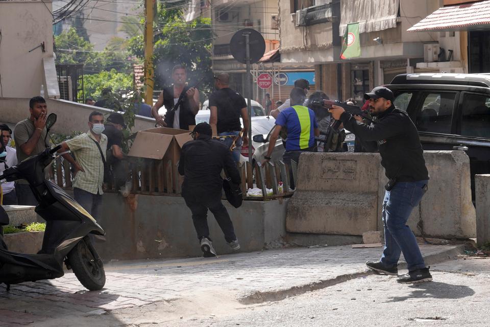 Supporters of a Shiite group allied with Hezbollah help an injured comrade during armed clashes that erupted during a protest in the southern Beirut suburb of Dahiyeh, Lebanon, Thursday, Oct. 14, 2021.