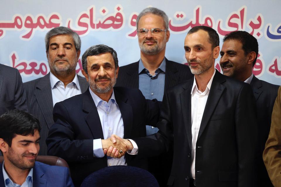 Former Iranian President Mahmoud Ahmadinejad, center, and his close ally Hamid Baghaei shake hands after registering their candidacy for the presidential elections in Tehran, 2017. Public officials in Iran are never seen wearing neckties, and although their sale is banned in the country it isn't illegal to wear them.