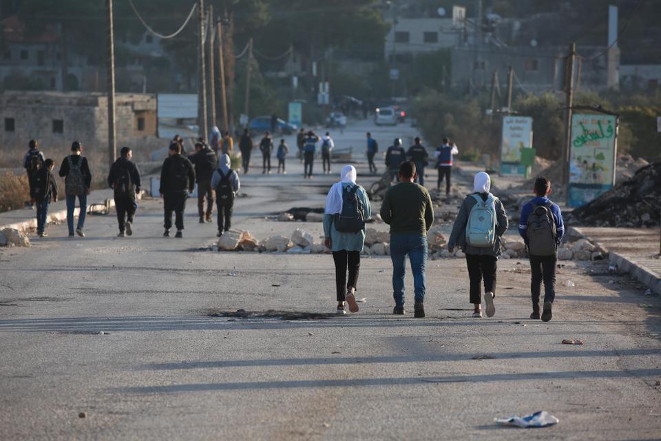 Palestinian students go to their schools with the fear of being attacked by Israeli soldiers or Jewish settlers as Jewish settlers had previously attacked two schools and their students in the neighborhood.