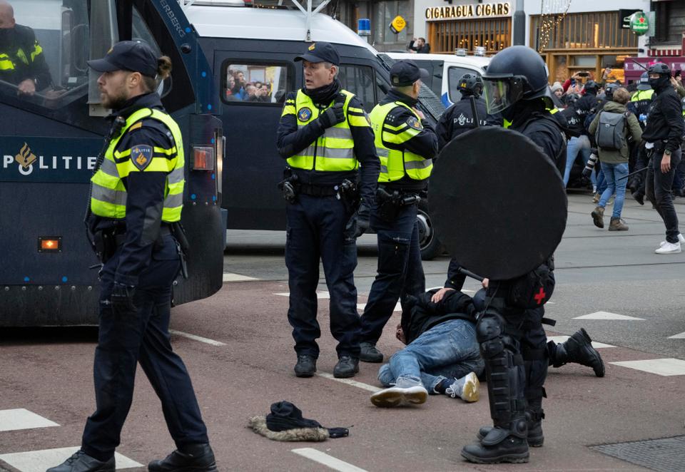 Police arrested demonstrators as thousands opposed the Dutch government's ban on rallies and protests 