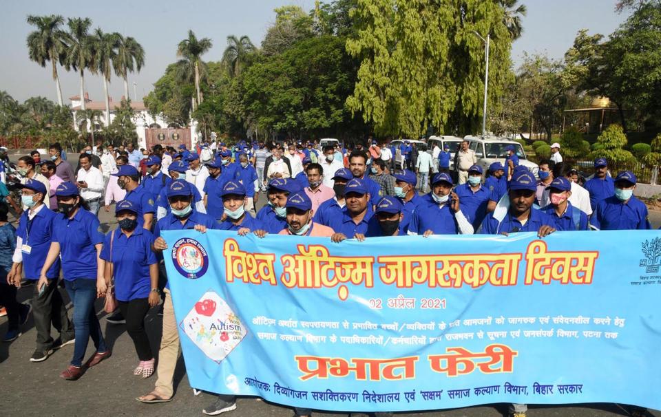 People participate in 'Prabhat Pheri' on the occasion of World Autism Awareness Day, outside Raj Bhawan, on April 2, 2021 in Patna, India.