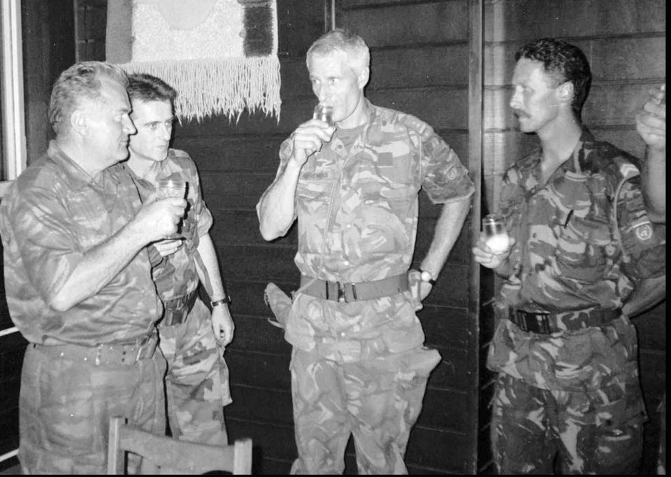 Bosnian Serb General Ratko Mladic, left, who was later sentenced to life in prison being guilty of genocide against Muslim Bosniaks, drinks toast with Dutch UN Commander Tom Karremans, second right, in 1995.