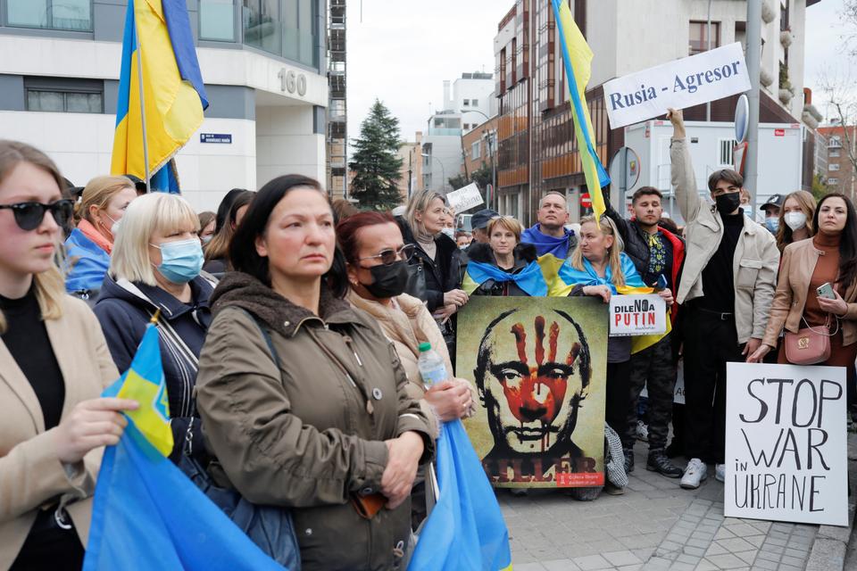 Protesters gather during a protest in front of the Russian embassy in Madrid, Spain.