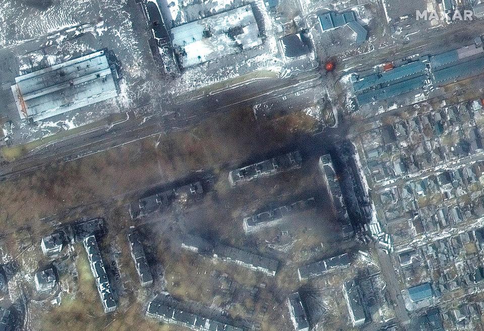 This multi-spectral satellite image provided by Maxar Technologies shows a close-up view of apartment buildings and fires that caused damage in the area of ​​Zhovtnevyi district in western Mariupol, Ukraine, during the Russian assault , Saturday, March 12, 2022.