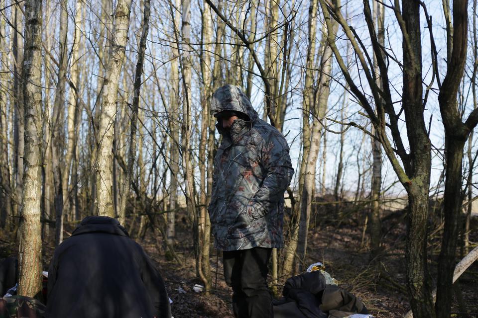 Ferhad, an Iraqi Kurd who has been stuck in a camp in Belarus for four months, wearing a new rain jacket he received from the NGO.