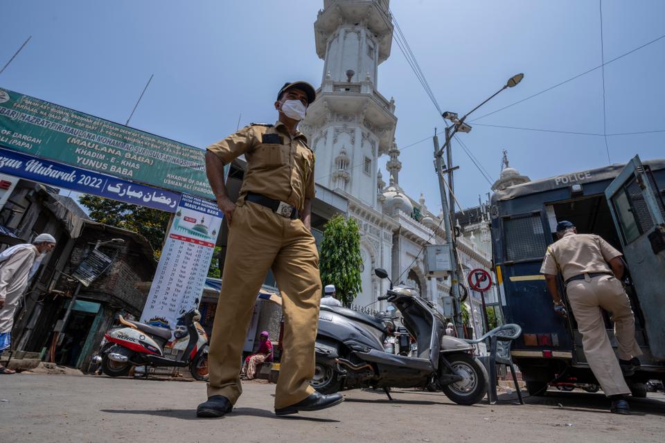 Indian policemen patrol outside a mosque in Mumbai after Hindu nationalists have escalated tensions over loudspeakers for Islamic call to prayer.