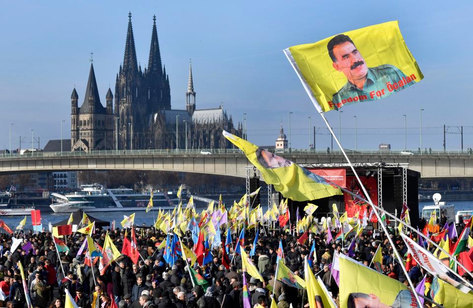 Pro-PKK demonstrators stage a rally against the Turkish government, displaying PKK flags and a portrait of group leader Abdullah Ocalan, in Cologne, Germany, in 2016.