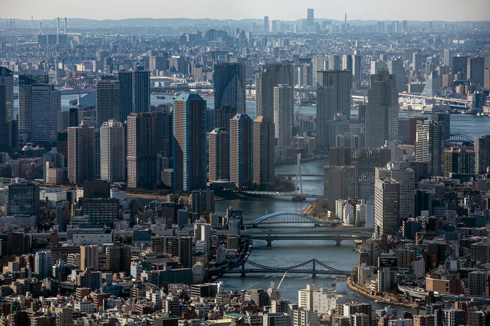 An aerial view of skyscrapers and densely populated buildings is seen from an observation deck in Tokyo.