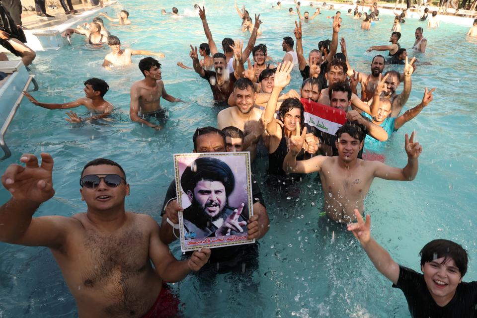 Supporters of Iraqi populist leader Muqtada al Sadr swim after they breach the Republican Palace in protest in Baghdad's Green Zone in Iraq on August 29, 2022.