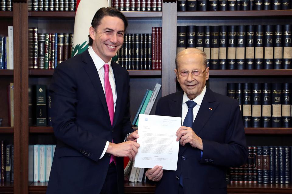 In this photo released by official Lebanese government photographer Dalati Nohra, Lebanese President Michel Aoun, right, receives a copy of the Washington-brokered agreement for the demarcation of the maritime border between Lebanon from US energy envoy Amos Hochstein and Israel, in Beirut, on October 27, 2022.