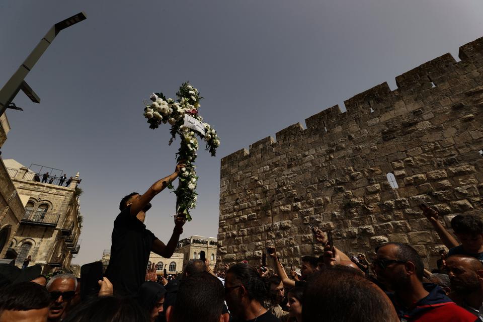 Palestinians attend the funeral procession of slain Al Jazeera journalist Shireen Abu Akleh at The Greek Catholic Patriarchate in Jerusalem's Old City on May 13, 2022.