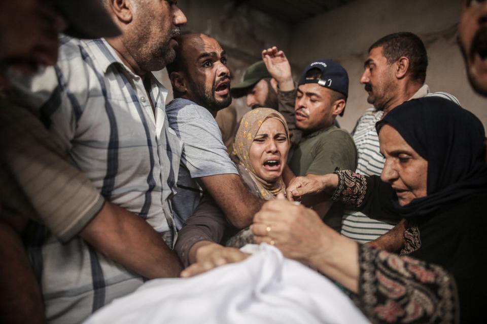 A Palestinian family mourns over the body of their relative, Ibrahim Ebu Salah, who was seriously wounded during Israel's attacks on Gaza in August and died of his injuries. His funeral was held in Beit Hanoun, Gaza City, Gaza on August 10, 2022.