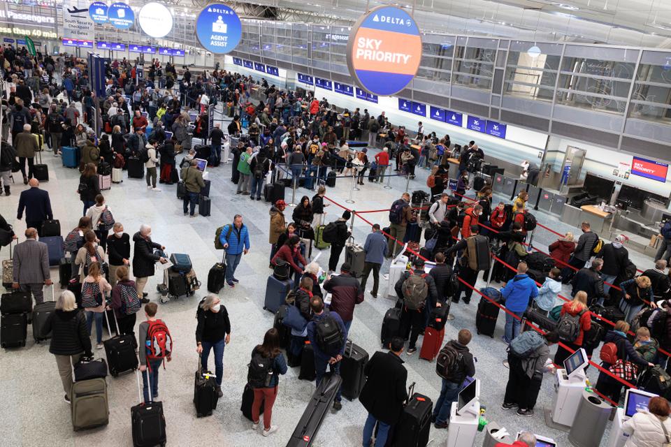 Travelers wait in line to check-in for their flights at Terminal 1 ahead of the Christmas Holiday at MSP Airport in Bloomington, Minnesota.